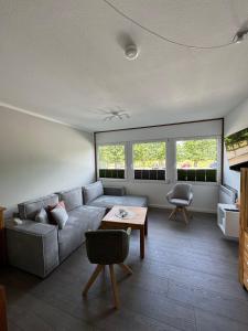 a living room with a couch and a table at Beachpoint-Fehmarn in Burgtiefe auf Fehmarn 