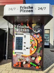 a pizza dispenser in front of a store at Beachpoint-Fehmarn in Burgtiefe auf Fehmarn  +4 photos