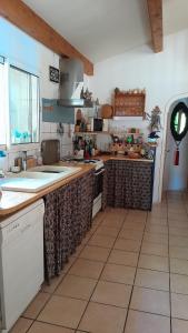 a large kitchen with a counter top and a counter top at Verdure, rivière et vue imprenable in Sallelles +1 photo