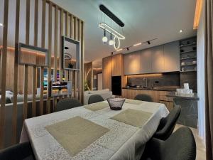 a dining room with a table and a kitchen at Luxury Apartment in Shkodër