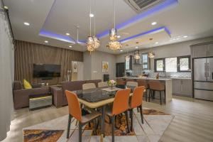 a dining room and kitchen with a table and chairs at Golden Pear Villa-MSV 10BR - 5 Fully Equipped Kitchens, Harbor & Sea Views in Morne Longue