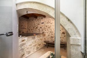 a room with a stone wall and a table at MERAKI residence in Atsipopoulo +50 photos