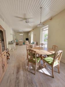 a large living room with a table and chairs at Clariston in Bridgetown