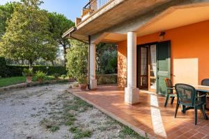 an orange house with a patio with a table and chairs at Vecchia San Giovanni - YourPlace Abruzzo in Fossacesia