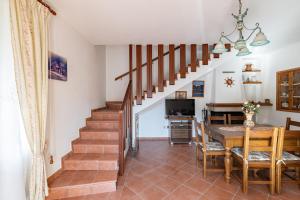 a staircase in a living room with a table and a dining room at Vecchia San Giovanni - YourPlace Abruzzo in Fossacesia +18 photos