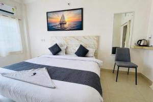 a bedroom with two beds and a sailboat on the wall at Hotel The regal inn in Varanasi