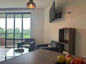 a living room with a table with fruit on it at Monoambiente 2 Village Golf in Yerba Buena