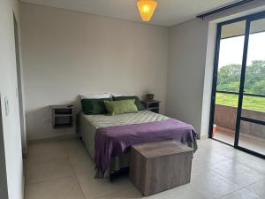 a bedroom with a bed in a room with a window at Monoambiente 2 Village Golf in Yerba Buena