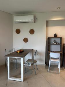 a dining room with a table and chairs and a window at Monoambiente 2 Village Golf in Yerba Buena +8 photos