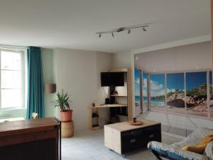 a living room with a couch and a tv in it at vaste T2 en Auvergne in Vic-le-Comte