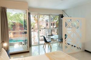 a bedroom with a bed and a table and a window at Feel Buenos Aires Apartments in Buenos Aires