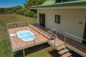 a deck with a hot tub on top of a house at Villa Kiskadee - Beautiful Mountain Views with Private Pool in Quepos