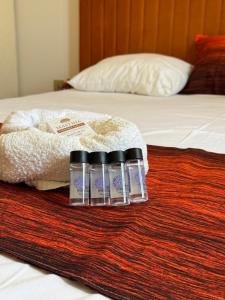 a group of three bottles of water sitting on a bed at K A P Home in Chios