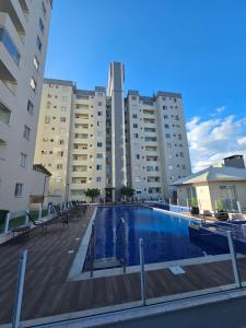 a swimming pool in front of a large building at Apto.napraia BEACH 901 em Piçarras com vista mar in Piçarras