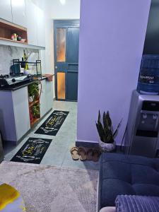 a kitchen with a couch and a kitchen with a stove at Tsavo Stanley in Kiambu