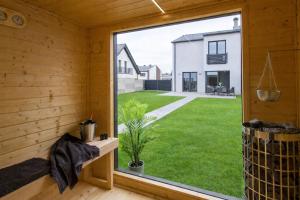 a window in a room with a view of a yard at Prestige House Jacuzzi & Sauna in Gdańsk