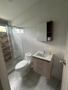 a bathroom with a toilet and a sink and a shower at Apartamento completo cerca del centro in Montería +33 photos