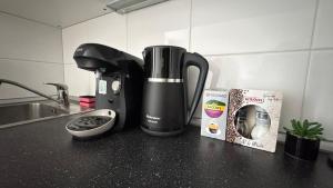 a coffeemaker sitting on a counter next to a sink at THE RIVERSIDE APARTMENT with Balcony in Prague