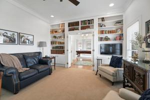 a living room with a couch and chairs and a television at Red Bluff Cottage in Montgomery