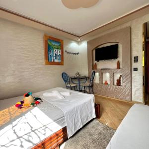 a bedroom with a bed and a table with chairs at Hôtel nabil akchour in Akchour +10 photos