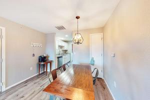 a dining room and kitchen with a table and chairs at Vineyards 2909 #3 in Branson +13 photos