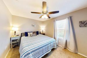 a bedroom with a bed and a ceiling fan at Vineyards 2909 #3 in Branson