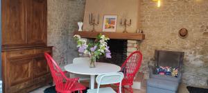 a table and chairs with a vase of flowers on it at location 24h du Mans in La Ferté-Bernard