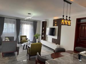 a living room with a table and some chairs at Elp Living in Hoima