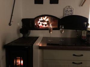two glasses of wine on a counter with a fireplace at Dalälven Strand in Södersätra