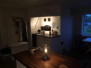 a small kitchen with a candle on a wooden table at Dalälven Strand in Södersätra +23 photos