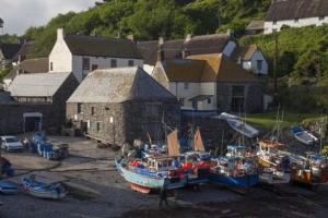 a group of boats parked in front of a building at Pebbles in Cadgwith +5 photos