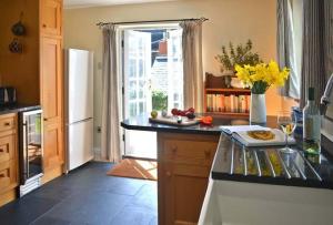 a kitchen with a white refrigerator and a counter top at Pebbles in Cadgwith