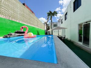 a swimming pool with a pink flamingo in a building at Downtown Suites - Hotel Boutique by Maraf in Cancún