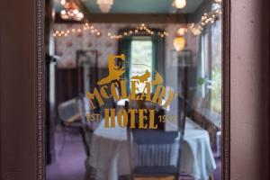 a reflection of a restaurant sign in a window at McCleary Hotel in McCleary