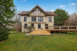 a house with a porch and a wooden deck at McCleary Hotel in McCleary