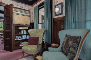 a living room with a chair and a book shelf at McCleary Hotel in McCleary