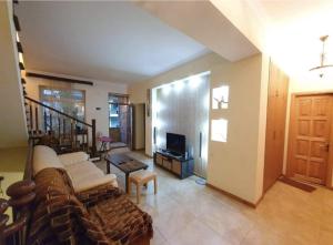 a living room with a couch and a tv at M&W Hostel in Yerevan