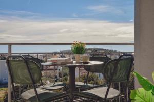a table and chairs on a balcony with a view at Sevid Seaview Apartments in Sevid