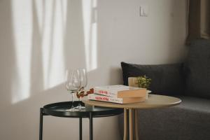 a table with a glass of wine and a book and a wine glass at Sevid Seaview Apartments in Sevid +38 photos