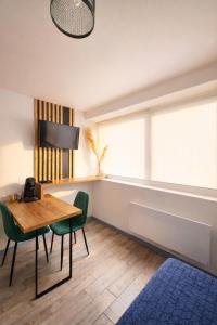 a dining room with a table and chairs and a window at Chez Coco - Studio à 200m de la Gare ! in Besançon