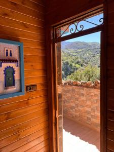 an open door to a room with a view of a mountain at Hôtel nabil akchour in Akchour