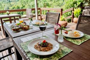a table with a plate of food and a glass of wine at Hotel Fazenda Vale Alvorada in Toledo +108 photos