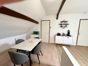 a dining room with a table and chairs at Le refuge des Ormes in Les Ormes