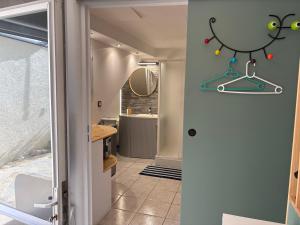 a hallway with a bathroom with a mirror at Coconning studio in Plauzat