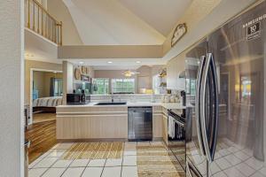 a large kitchen with a refrigerator and a sink at On the Green in Branson