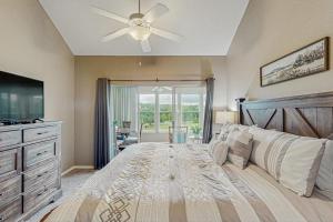 a bedroom with a large bed with a ceiling fan at On the Green in Branson +13 photos