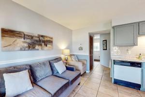 a living room with a couch and a kitchen at Fall Creek Resort Pond View Escape in Branson +13 photos