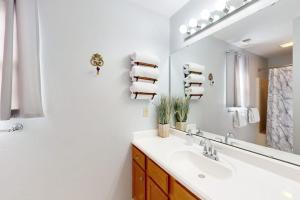 a bathroom with a sink and a mirror at Fall Creek Resort Pond View Escape in Branson