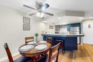 a kitchen and dining room with a table and chairs at Overlook Retreat, Apt. 3 in Branson