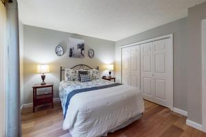 a bedroom with a bed and two tables with lamps at Overlook Retreat, Apt. 3 in Branson